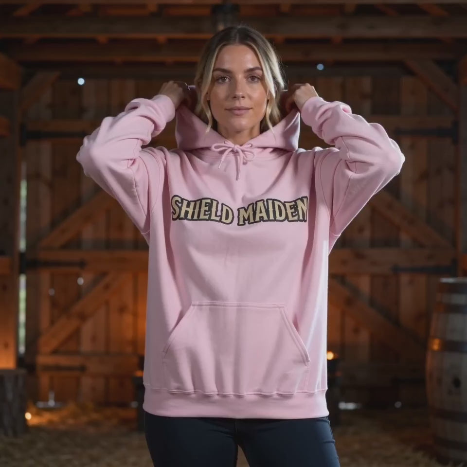 Product video showcasing the light pink Shield Maiden Norse Heritage Hoodie with Shield Maiden lettering.